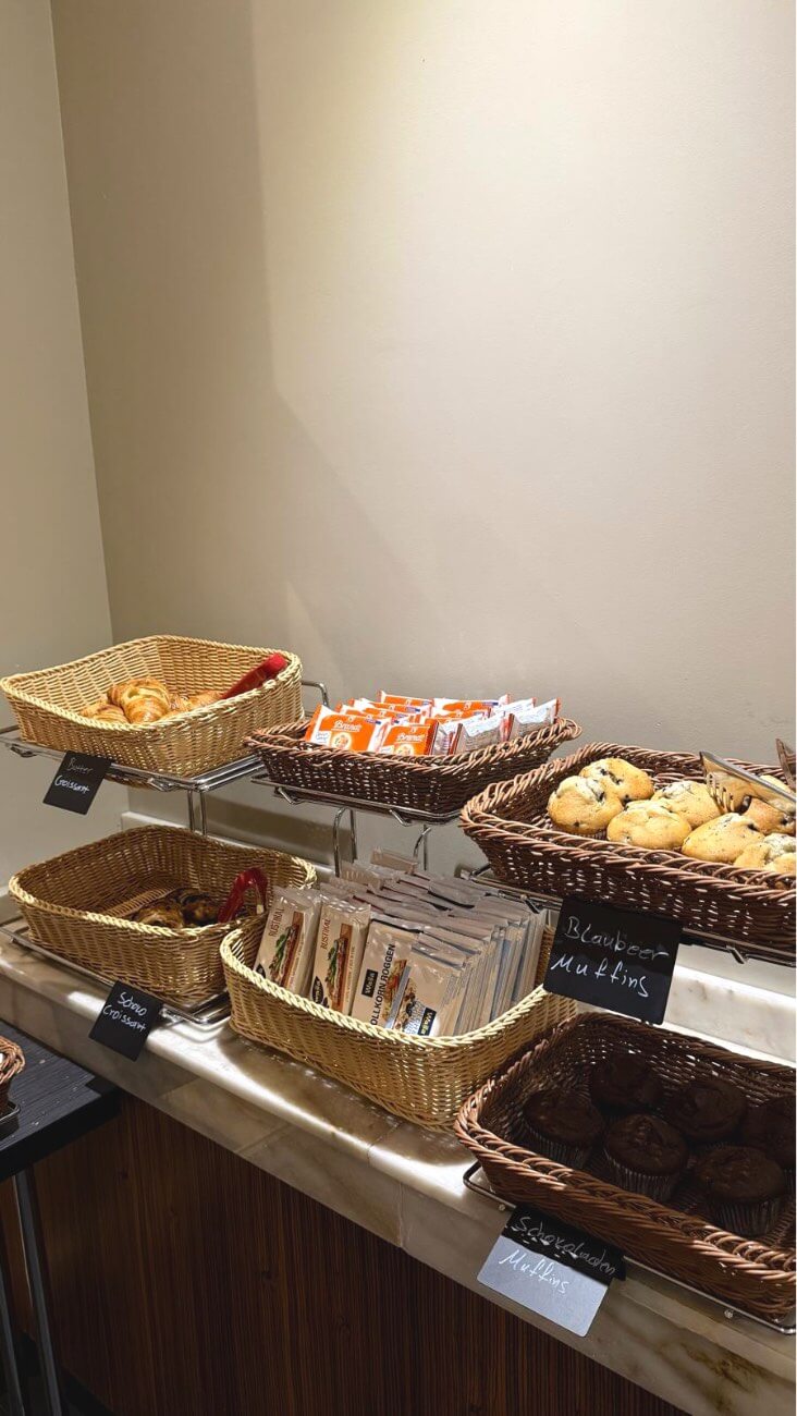 Pastries, croissants and muffins in breakfast baskets.