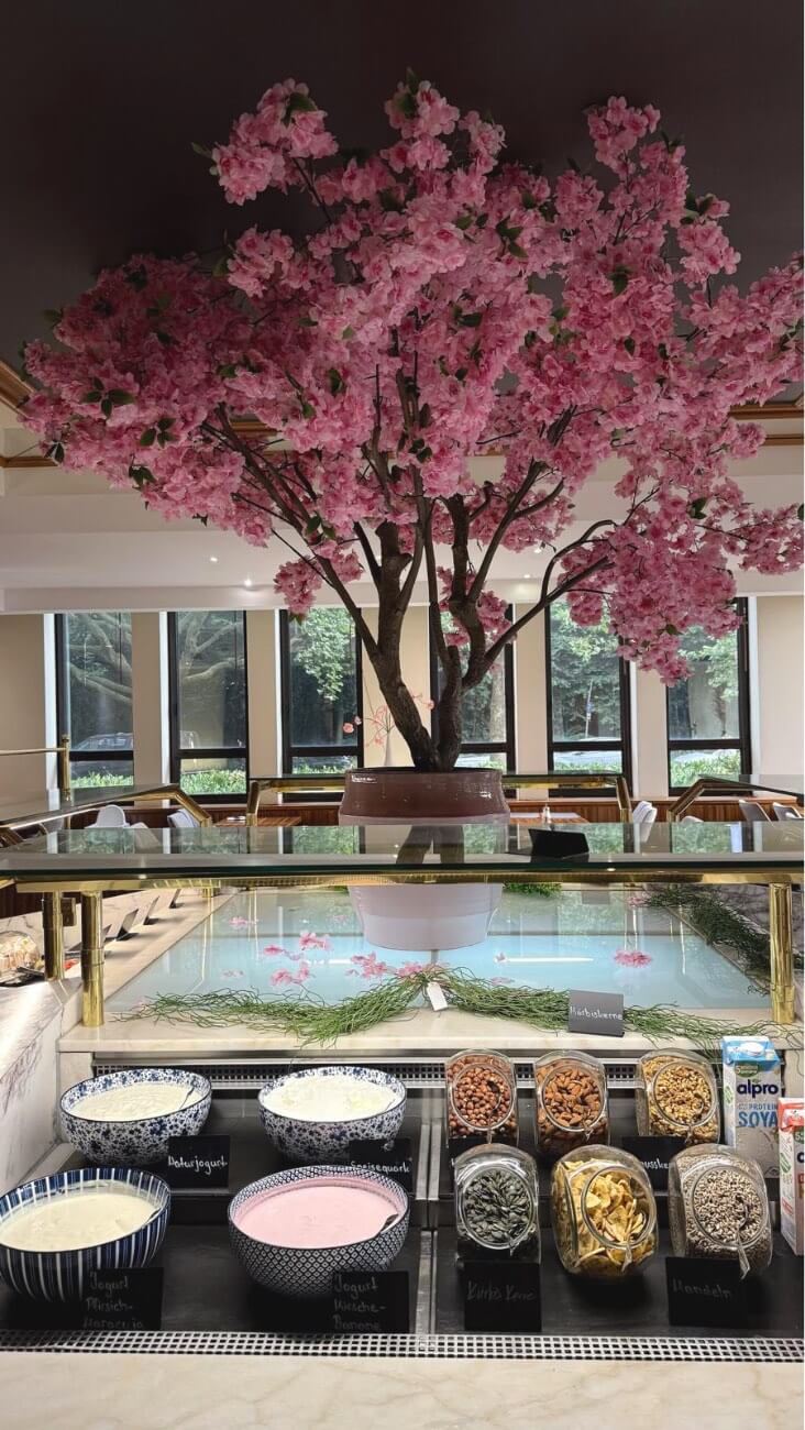 Yogurt, toppings, nuts and milk alternatives at the breakfast buffet.